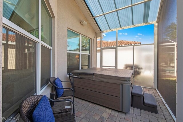 view of patio / terrace with a hot tub