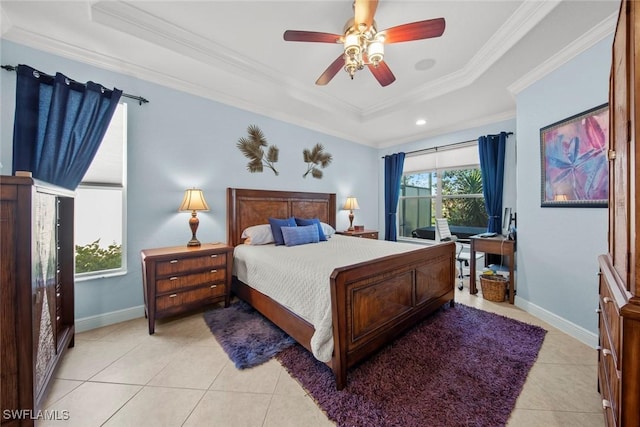 tiled bedroom featuring a tray ceiling, ceiling fan, and ornamental molding