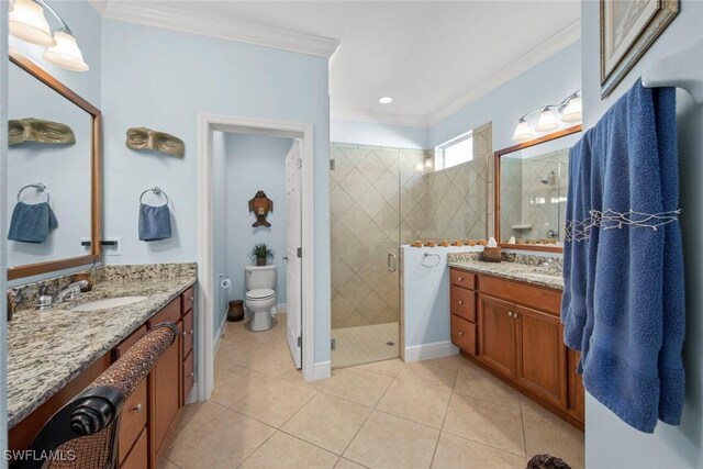 bathroom with tile patterned flooring, vanity, crown molding, and walk in shower