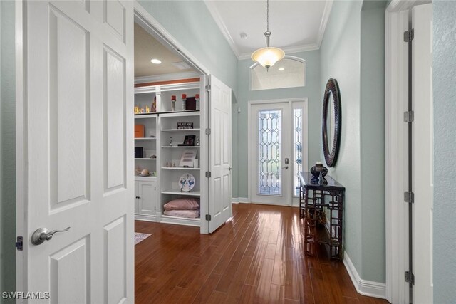 entryway featuring dark hardwood / wood-style flooring and crown molding