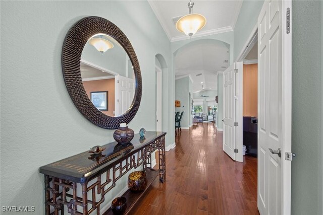 corridor featuring dark wood-type flooring and crown molding