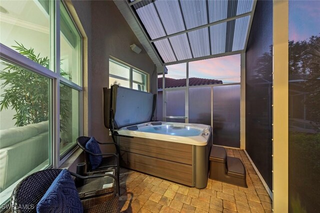 sunroom featuring a jacuzzi and vaulted ceiling