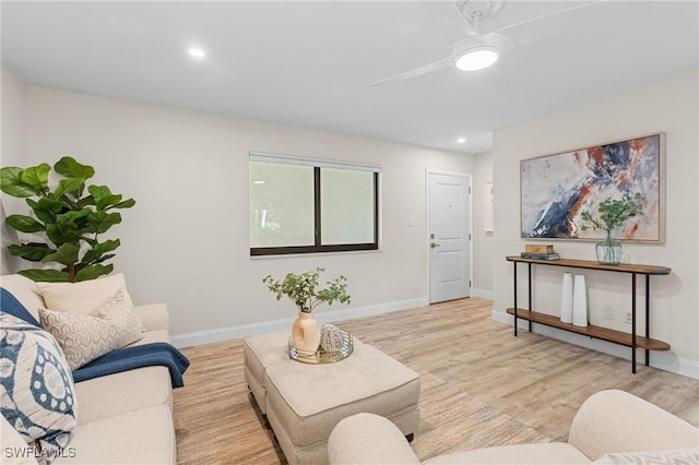 living room with ceiling fan and light hardwood / wood-style flooring