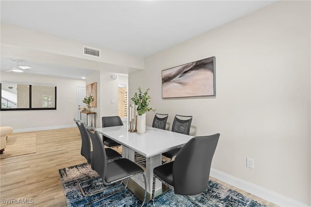 dining space featuring wood-type flooring