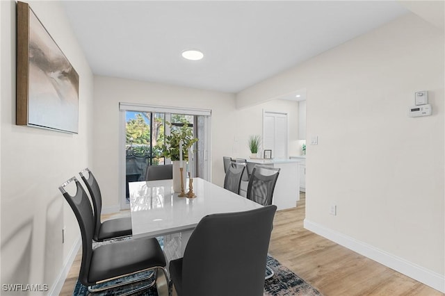 dining space with light wood-type flooring