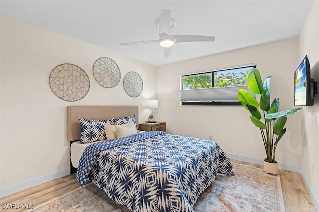 bedroom with ceiling fan and light wood-type flooring