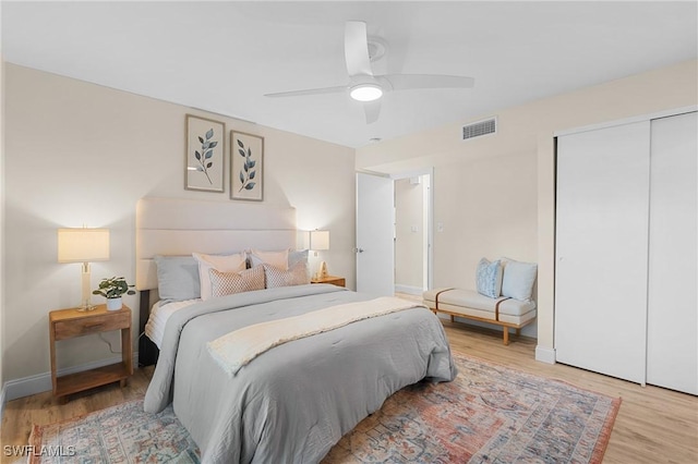 bedroom featuring a closet, light hardwood / wood-style floors, and ceiling fan