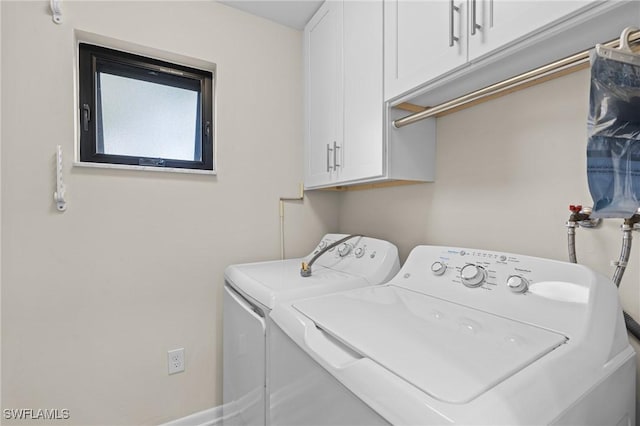 laundry room featuring cabinets and independent washer and dryer