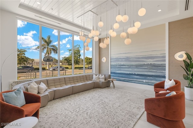 living area featuring a tray ceiling and recessed lighting