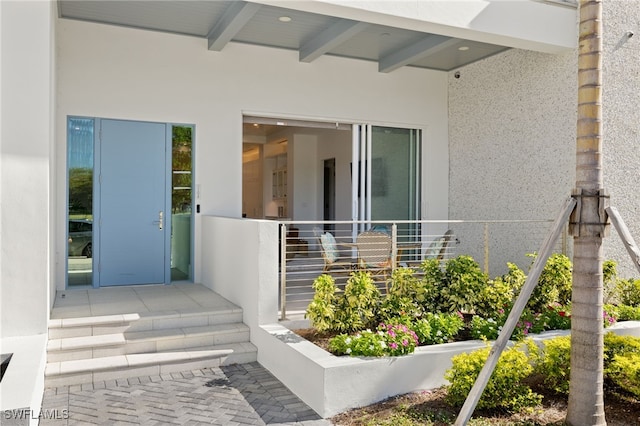 doorway to property with stucco siding