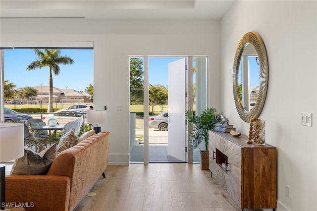 entryway featuring light wood finished floors and baseboards