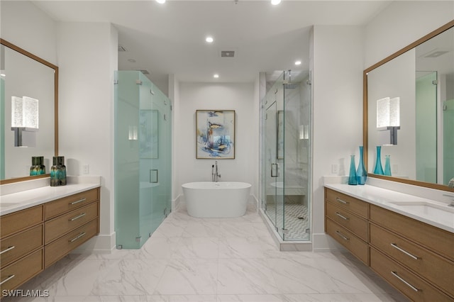 bathroom featuring a freestanding tub, recessed lighting, vanity, marble finish floor, and a stall shower