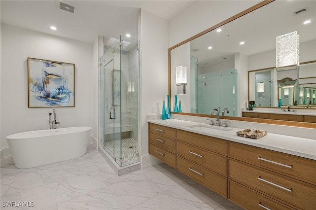 bathroom with recessed lighting, vanity, a freestanding bath, marble finish floor, and a shower stall