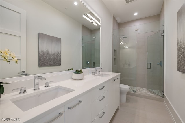 bathroom featuring toilet, a stall shower, tile patterned flooring, and a sink