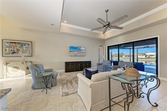 living room featuring crown molding, a raised ceiling, and ceiling fan