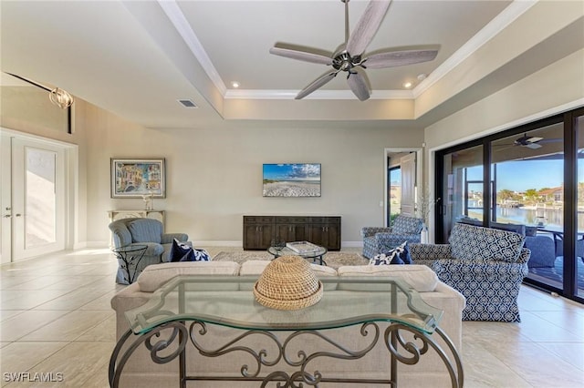 tiled living room with ceiling fan, crown molding, french doors, and a raised ceiling