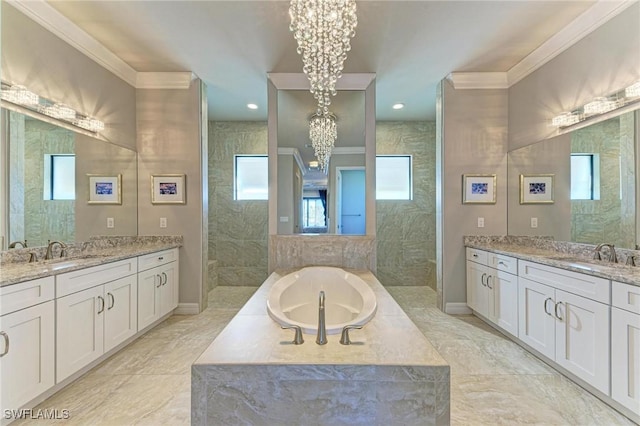 bathroom featuring vanity, tiled tub, crown molding, and a chandelier