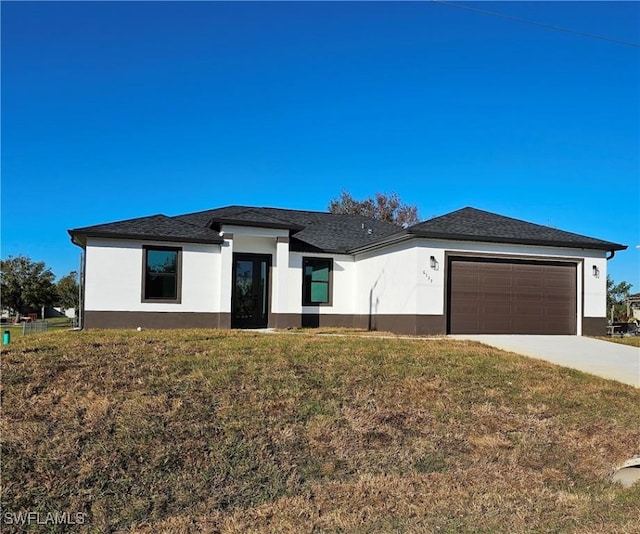 view of front of home featuring a garage and a front lawn