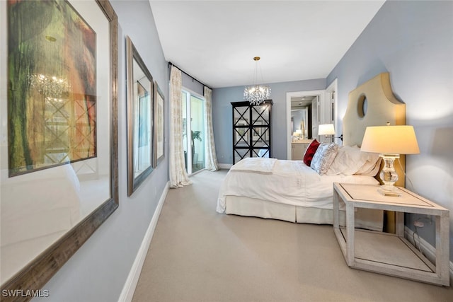 bedroom with carpet floors, a notable chandelier, and baseboards