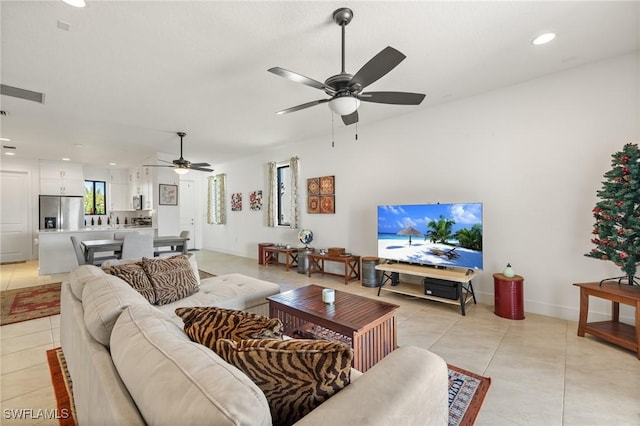 living room featuring ceiling fan and light tile patterned floors