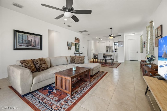 living room featuring light tile patterned floors and ceiling fan