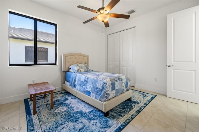 bedroom featuring a closet, tile patterned floors, and ceiling fan