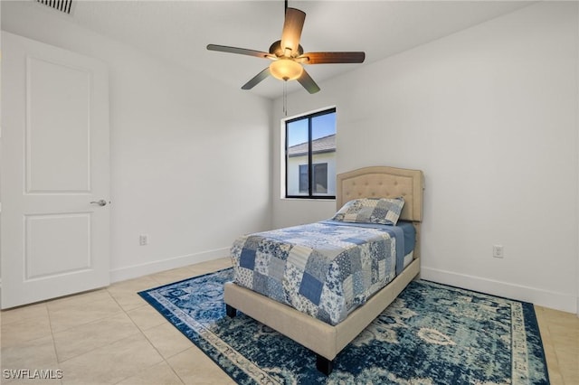 tiled bedroom featuring ceiling fan