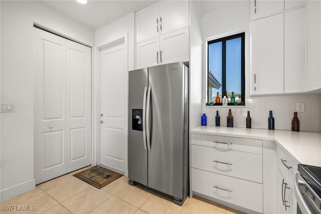 kitchen featuring white cabinets, light tile patterned floors, and appliances with stainless steel finishes