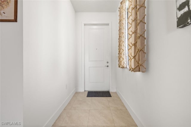 doorway to outside featuring light tile patterned floors