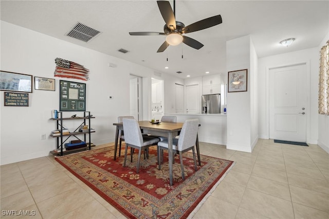 tiled dining space with ceiling fan