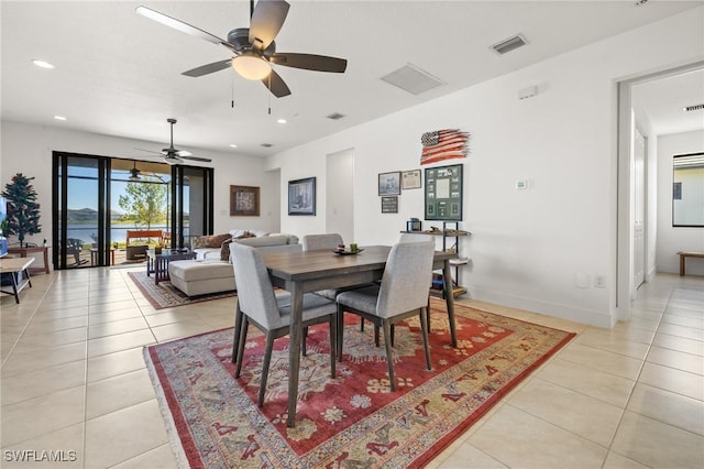 tiled dining area with ceiling fan