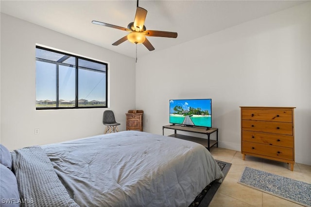 tiled bedroom featuring ceiling fan