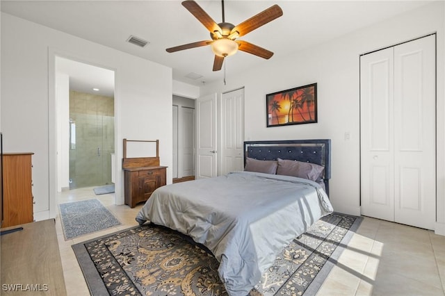 tiled bedroom featuring ceiling fan, connected bathroom, and multiple closets