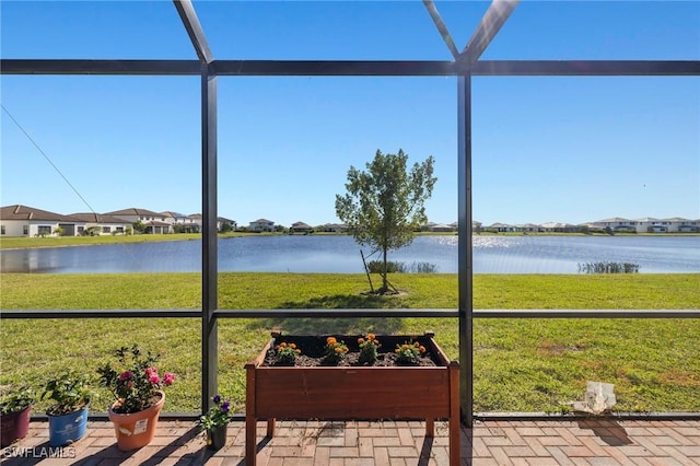 sunroom with a water view and a wealth of natural light