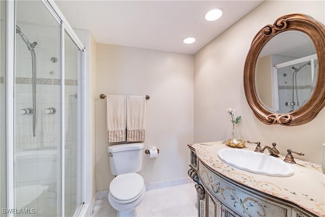 bathroom featuring tile patterned flooring, vanity, toilet, and a shower with door