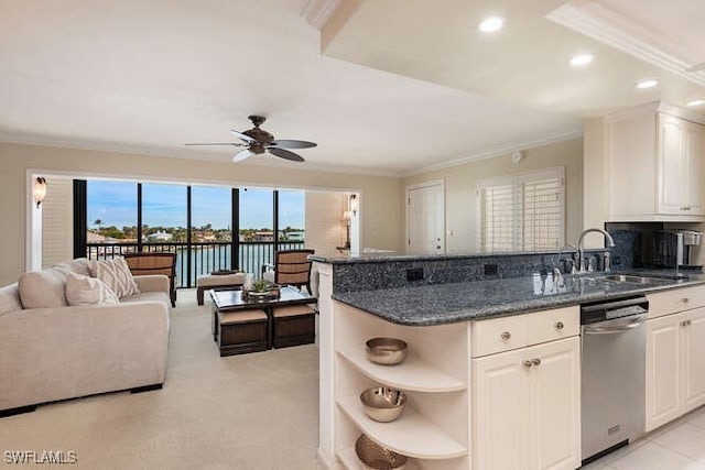 kitchen featuring sink, stainless steel dishwasher, ceiling fan, dark stone countertops, and white cabinetry