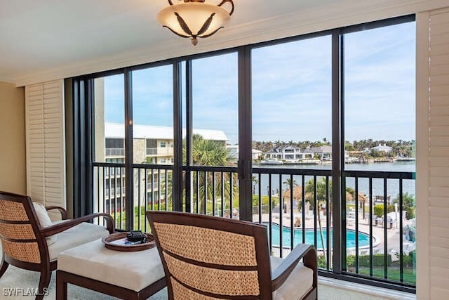 sunroom / solarium with a water view