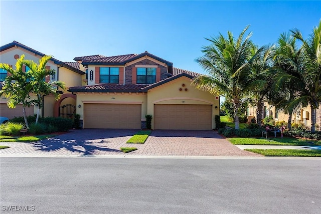 mediterranean / spanish-style house with a garage