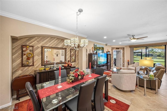 tiled dining area with crown molding, wooden walls, and ceiling fan with notable chandelier