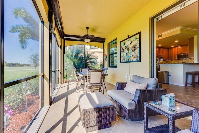 sunroom with ceiling fan