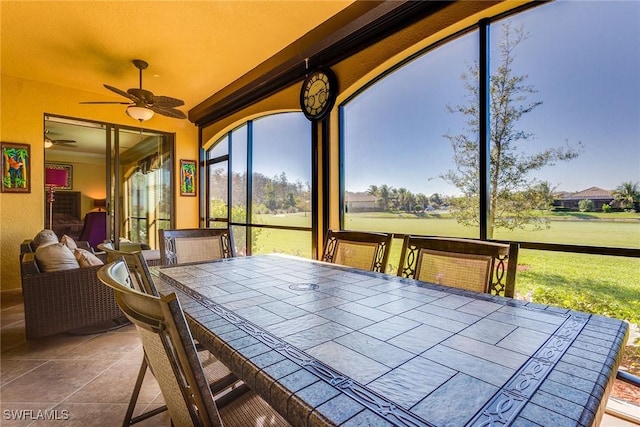 sunroom / solarium featuring ceiling fan