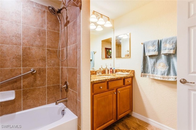 bathroom featuring vanity and tiled shower / bath