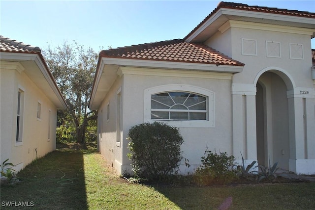 view of property exterior featuring a lawn