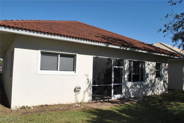 view of side of home with a lawn