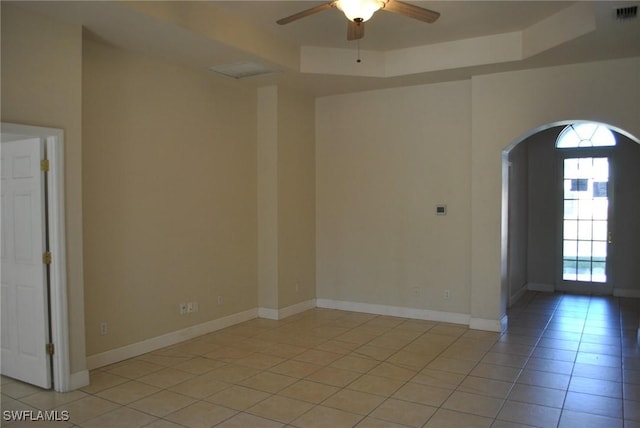 spare room featuring ceiling fan and light tile patterned floors