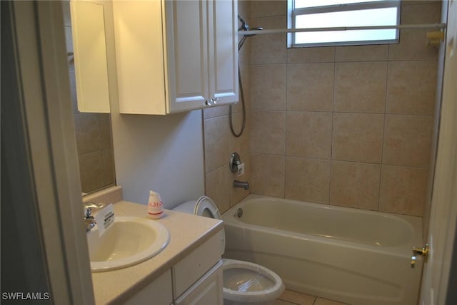 full bathroom featuring vanity, tiled shower / bath combo, and toilet