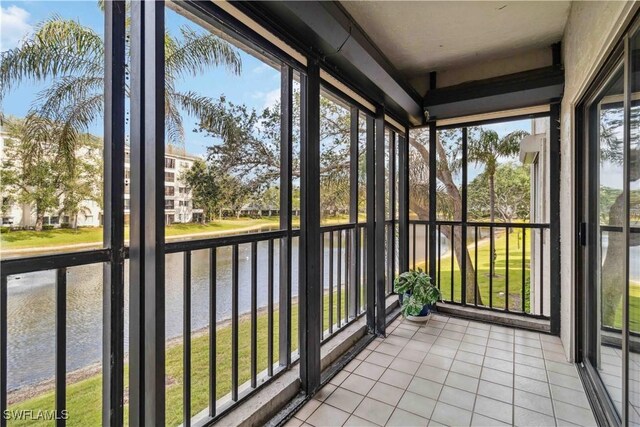 unfurnished sunroom featuring plenty of natural light and a water view