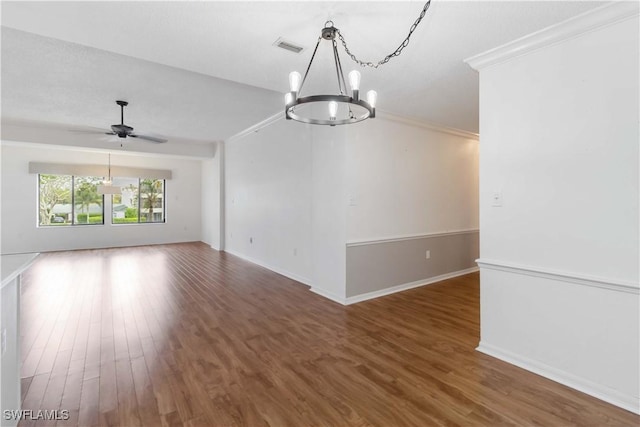 unfurnished room featuring ceiling fan with notable chandelier, crown molding, wood finished floors, and visible vents