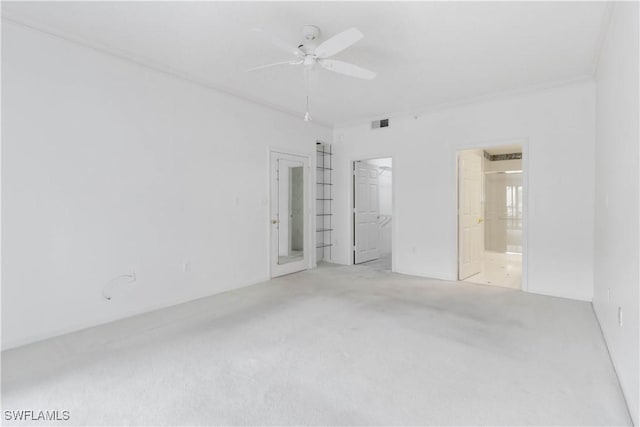 unfurnished bedroom featuring visible vents, a walk in closet, ensuite bathroom, and ceiling fan