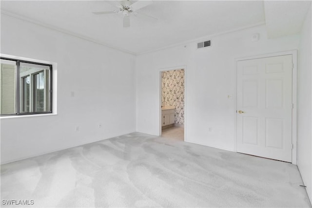 unfurnished room featuring visible vents, carpet, ornamental molding, and a ceiling fan